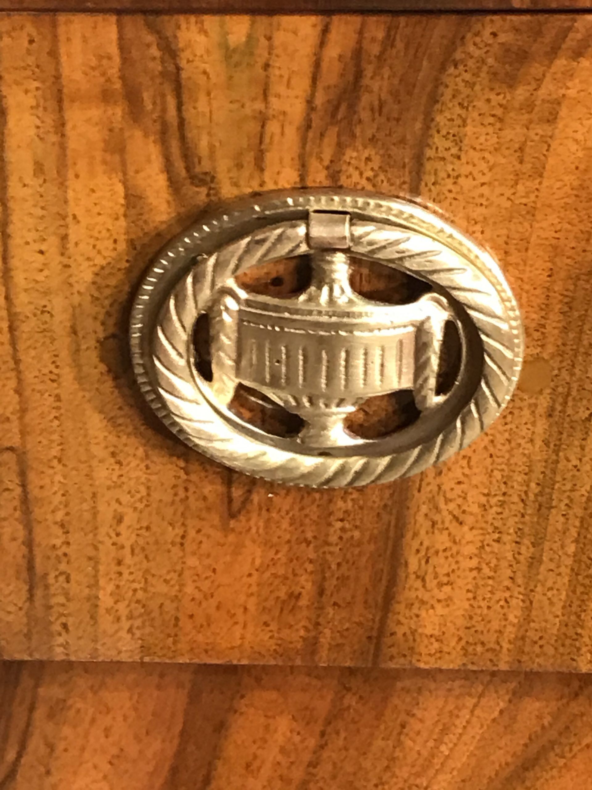 Biedermeier walnut dresser- detail of a brass fitting- styylish