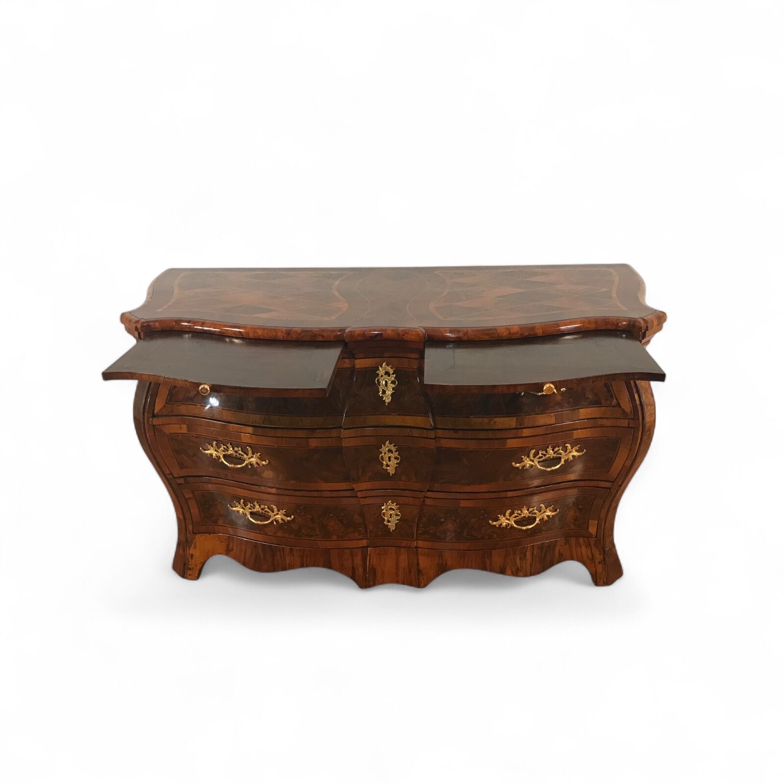 Front view of 18th century German Baroque chest of drawers (c. 1750) with bombe shape, walnut veneer, intricate marquetry top, root walnut accents, two pull-out shelves, three spacious drawers, and original 18th century ormolu fittings- Styylish